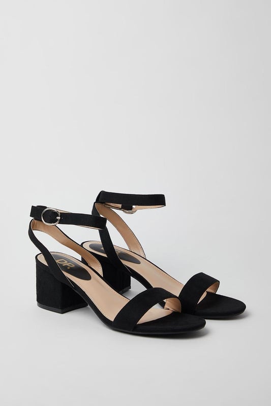 Wide fit design offers a comfortable and accommodating fit
Barely-there strappy silhouette with minimalist appeal
Mid block heel provides a modest lift and walkable height
Faux leather upper exudes a look and feel
Ankle strap with buckle closure ensures a secure fit

These versatile sandals are perfect for casual daytime outings or relaxed evening affairs. Pair them with a flowy midi dress or cropped trousers for a chic, on-trend look that transitions seamlessly from brunch with friends to an evening baby shower. The neutral hue complements a variety of ensembles, allowing you to showcase your personal style effortlessly.