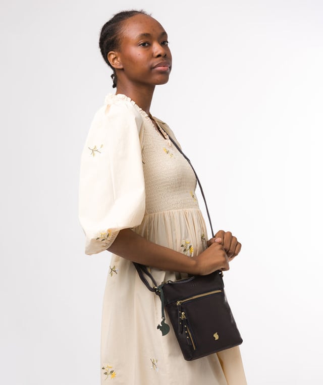 The 'Elf' cross body bag from Conkca London is handcrafted from multi-toned leather for a beautiful finish. A zip-over top opens to reveal a spacious compartment with two slip pockets, lined with natural and untreated 100% cotton. Features two zipped pockets on the front of the bag and a slip pocket on the rear. Comes with an adjustable leather strap with a maximum drop length of 70cm. Adorned with the inimitable Conkca squirrel charm and Conkca logos.