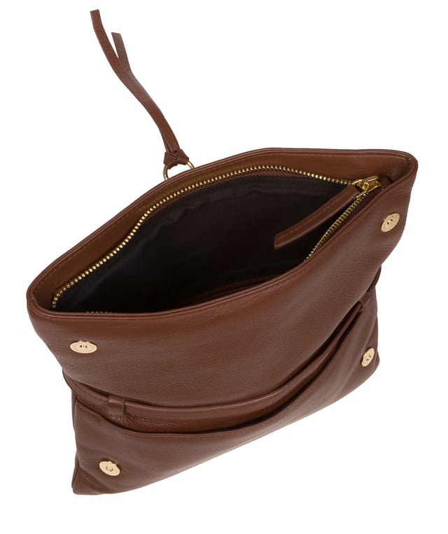The 'Selene' cross body clutch bag from the Pure Luxuries Marylebone Collection is handcrafted from high-quality, genuine Nappa leather with a natural super-soft touch. The fold-over top secured by two magnetic press studs, opens to reveal a zipped main compartment and a slip pocket. The interior is lined with 100% cotton and includes two slip pockets to help maintain an organised bag. Comes with a matching and adjustable slim leather strap, with a maximum drop length of 65cm. The strap is also removable, transforming the bag into a clutch bag. Features gold-coloured metal fittings and zip. The Pure Luxuries logo is embossed for an effortless and sophisticated finishing touch.