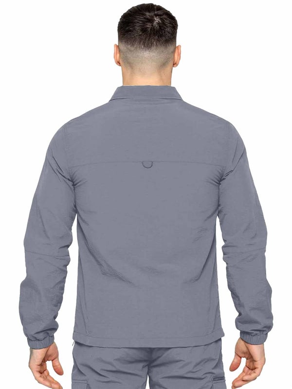 Expertly designed for outdoor activities and the transition to mid-season, this shirt jacket is constructed of crinkle nylon that is both water-repellent and wind-resistant. The fabric has a soft peach-fuzz feel and is complemented by a pointed collar, functional pockets, and a zip fastening to easily adjust the fit. The jacket is made with patch pockets and a flap on the chest, making it both functional and stylish.
