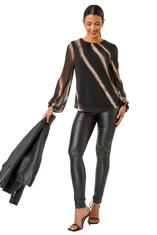 Stripe Print Mesh Overlay Top from Roman. Add a touch of elegance to your Autumn/Winter wardrobe with this chic mesh overlay top featuring an all over stripe print. With long sleeves and an elasticated cuff, this piece is designed with a classic round neck and falls to a flattering hip length. Perfect for layering over a camisole or fitted top, pair with tailored trousers and heels for a sophisticated look that transitions seamlessly from day to night!