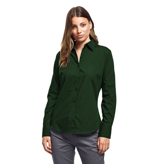 Womens easy care long sleeve blouse. Soft collar styling. Rounded bottom hem. Fitted styling with bust and back darts. Pearlised buttons on white shirt, self colour buttons on black. Double buttons on cuff. Size 6*, 8, 10, 12, 14, 16, 18, 20, 22, 24, 26 * size 6 only available in black and white. Bust: 6 - 35.5”, 8 - 37.5”, 10 - 39.5”, 12 - 41.5”, 14 - 43.5”, 16 - 45.5” 18 - 47.5”, 20 - 49.5”, 22 - 51.5”, 24 - 53.5”, 26 - 55.5”. Fabric 65% Polyester, 35% Cotton. Plain Poplin Weave Weight 105gsm