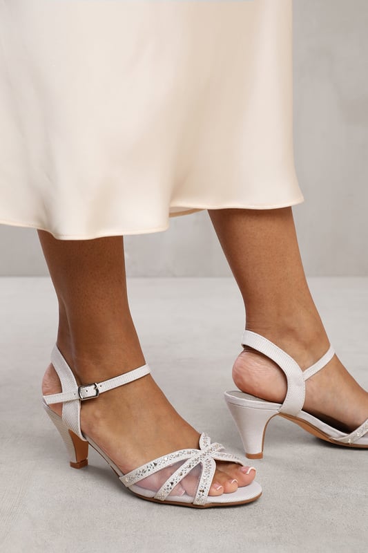 Step out in style with our Nymra Diamante Mesh Strappy Heel. These heels offer a perfect combination of sophistication, comfort, and versatility.Key Features:



Kitten Heel: The kitten heel of these shoes provides a touch of elegance and femininity. With a modest height, it offers a comfortable and stable walking experience, making it ideal for all-day wear.

Mesh Detail: The mesh detail adds an element of sophistication to any outfit

Strappy Design: The strappy design creates an intricate and eye-catching look that enhances the overall style. The straps also provide additional support and security, ensuring a comfortable fit.

Open Toe: The open toe design allows your feet to breathe and stay cool during warm weather. It also adds a fashion-forward element, making these heels perfect for showing off a pedicure or adding a touch of flair to any outfit.

Durable Construction: These heels are made from high-quality materials, ensuring durability and longevity. The sturdy construction and quality materials make these heels a reliable choice that can withstand everyday wear and tear.


Specifications:


Design: Kitten heel strappy sandals with open toe
Heel Height: 2.5' (6.3cm) approx
Closure: Adjustable buckle strap for a secure fit

Step up your footwear game with our Nymra Diamante Mesh Strappy Heel. These heels offer a combination of style and comfort, ensuring you look and feel your best all day long. Elevate any outfit with these versatile and fashionable heels.