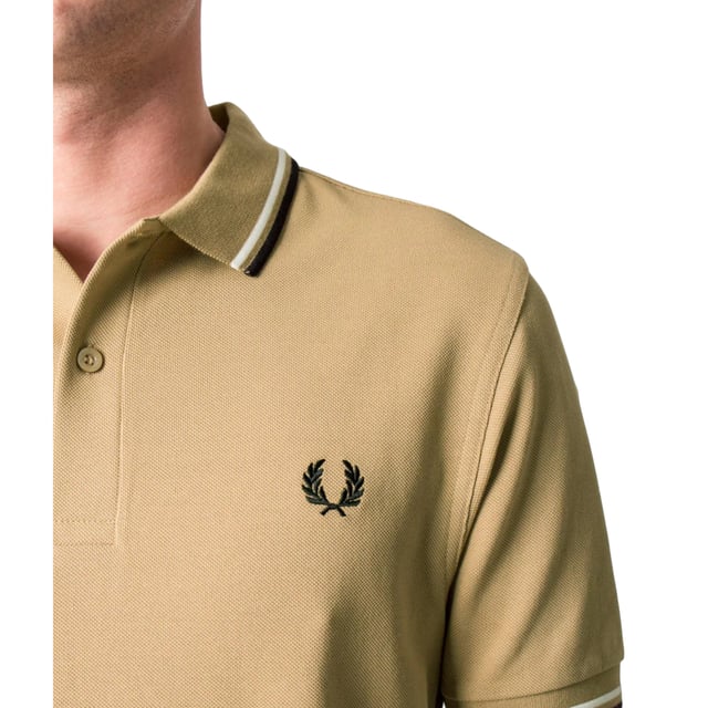 The Twin Tipped Fred Perry Polo Shirt by Fred Perry is a short sleeved polo shirt that has been made from Fred Perry's classic cotton piqué, in a contemporary adaptation of Fred's famous streamlined fit. Available in a diverse range of colourways - each with their own unique story. Featuring the signature Fred Perry wreath logo to the chest and twin tipping to the collar and cuffs.