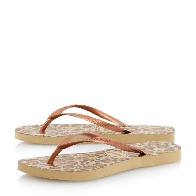 Create a glam beachside look in Havaianas' snake print design. Black, lilac and rose with metallic straps and slight wedge sole. Made in Brazil with non-slip finish, heat and water resistant.
