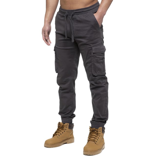 Enzo Mens Elasticated Waist Stretch Cuffed Jeans. Features a 5 Pocket Design. 2 Slash Pockets, 1 Back Pocket 2 Front Cargo, Bellow Side Pockets With Velcro Fastening. Elasticated Waist With Adjustable Drawstings. Cut and Sew Design On Leg. Cuffed Ankle