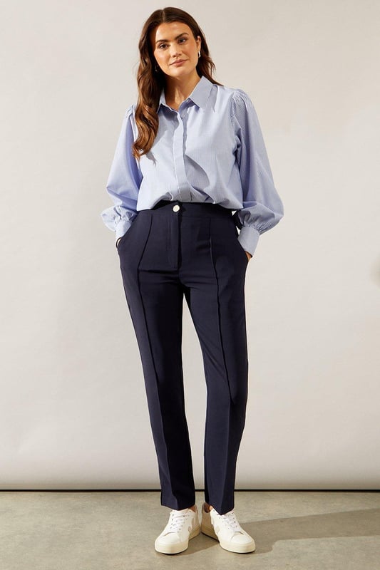 Tapered fit for a sleek silhouette
        Elegant split hem detail
        High-waisted design for a flattering fit
        Versatile style suitable for smart and casual occasions
        Comfortable stretch fabric for all-day wear
    
    These split hem tapered trousers from Wallis are the epitome of sophisticated style with a modern twist. The tapered fit creates a streamlined look that flatters your figure, while the split hem adds a touch of contemporary flair. Perfect for the woman who values both comfort and elegance, these trousers can effortlessly transition from day to night. Pair them with a crisp button-down shirt and blazer for a polished office ensemble, or dress them down with a silk blouse and statement jewellery for evening drinks. The high-waisted design not only accentuates your waistline but also provides a smooth foundation for tucked-in tops. Whether you're attending a formal event or aiming for a smart-casual look, these versatile trousers will ensure you always look put-together and feel confident.