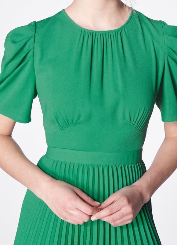 Full of vintage charm, our Avalon dress is a modern interpretation of beautiful Thirties' dress shapes. Crafted from stylish crepe in bright green, it has a round neck with pleat detail, folded short sleeves, pleating at the bust, a nipped waist and falls to a midi-length pleated skirt. Wear with a tweed jacket early in the season or with strappy heels for spring occasions.