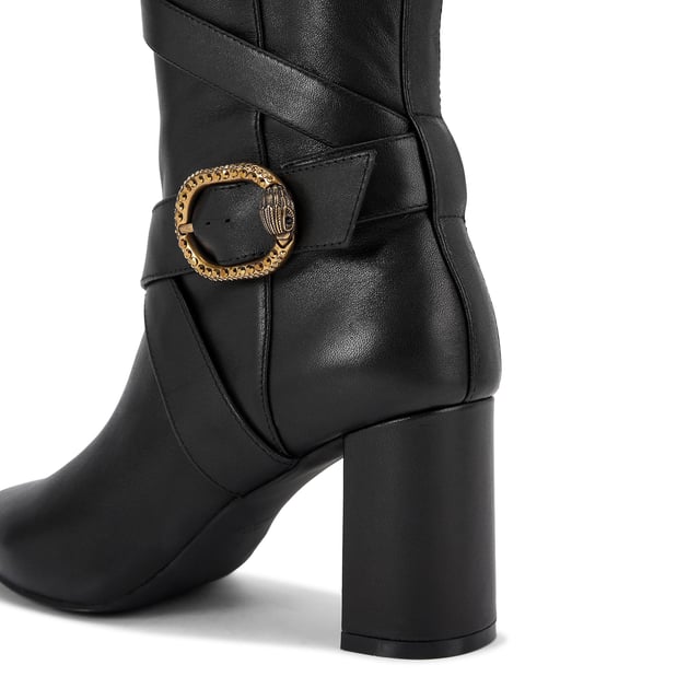 This Kurt Geiger Mayfair Strappy Knee high boot is crafted from a soft black leather with  strap detail up the entire shaft. There are two antiqued brass buckles with eagle heads across the straps. Heel height: 8cm.