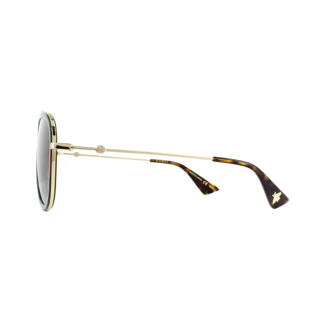 Gucci Sunglasses GG0062S 003 Gold Green Red Green Gradient are a super contemporary version of the classic aviator. The frame front and temple tips are crafted from acetate, and the temples, bridge and brow bar are made from metal, creating a cool contrast. Adjustable nose pads ensure the GG0062s have a personalised fit. Subtle branding can be found on the temples where the GG logo has been incorporated into the temple design.