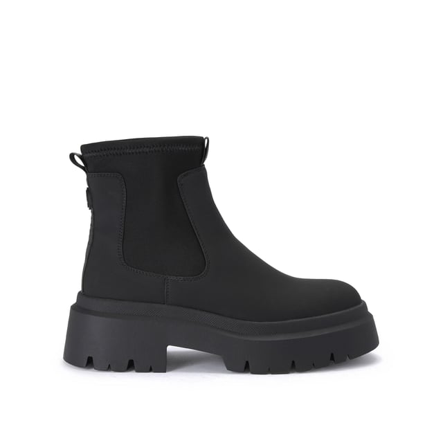 The Thea2 is a black boot with chunky style, there is a stretch ankle for slip-on ease. The sole is extra chunky with large tread. The back of the ankle features a brown monocle and KG Kurt Geiger branded tape.