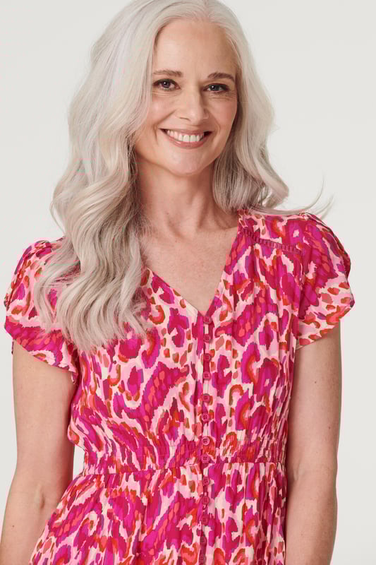 Add a statement maxi dress to your closet with this vibrant printed a-line dress. With a V-neck, a button front, frilled cap sleeves, pockets and a crochet detail tiered midi skirt. Style with blush heels and a clutch bag for a garden wedding or dress down on holiday with sandals.