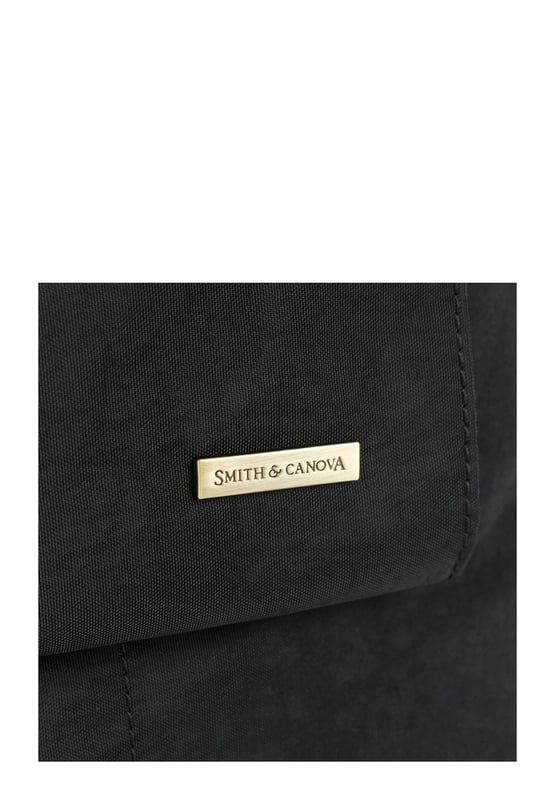 Made from our signature nylon, the Portrait Nylon Tote is the perfect way to carry all your everyday essentials. Featuring a padded carry handle and adjustable crossbody strap with a clip off function. Features: , Zip top opening, Front oversized flap over zip pocket, Rear zip pocket, SMITH & CANOVA antique brass logo, Branded antique brass zips, Padded grab handle, Adjustable crossbody strap (detachable), Internal 15 inch padded laptop sleeve, Internal zip pocket, 2 Internal mobile phone slip pockets - fits normal and plus size smart phones, 2 Internal pen slip pockets Style Ref: 92682 BLACK