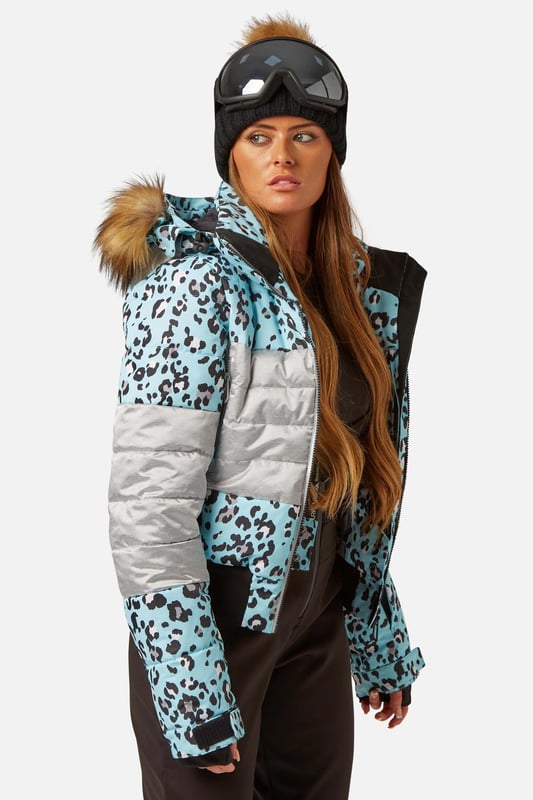 The Surfanic Fiore ski and snowboard jacket is a popular street-styled high-performance mountain jacket for all occasions. Classic feminine design with premium warmth, this low loft puffer jacket is filled with 100% recycled insulation that warms up as quickly as it dries out, for all-day comfort. This street-styled block gives you the right mix of form and function.

The Surftex 10K outer shell provides excellent waterproof protection from the winter elements, while the 10K breathability rating allows body heat and moisture to escape through the fabric for optimum comfort throughout the day. The jacket's shell fabric has a high-performance durable coating with taped seam construction that offers exceptional heat retention in cold conditions and a high level of breathability that ensures excess heat doesn't form into condensation on the inside of the jacket.

The detachable hood has a 3-way volume adjuster for increased all-round visibility when you are flying down the mountain and require the added protection of having your hood up and when the weather offers you a challenging day. The water-resistant front zipper has an internal reinforced storm flap for increased comfort and protection.

Powder skirt - Whether you're hitting the powder on skis or snowboard, this snow skirt creates a tight seal around your waist to keep the snow out and the warmth in. Made from durable waterproof materials and an internal dry butt patch (DBP) to keep it all warm and dry.

Snow cuff / wrist gaiter - This is perfect for even the most extreme conditions, featuring a tight seal that bridges the gap between your glove and jacket.

Zipped pockets - Pockets designed for everything plus a few more just in case. Pockets for goggles, lift pass, media, stash pocket for cash, wallet pocket and inside phone pocket for protection and to keep the battery warm and dry. Plus a detachable goggle wipe for those days when visibility is at a premium.

Design features:

    Detachable fur
    3-way volume adjusting hood
    Super soft chin guard
    Zipped sleeve ski pass pocket
    Snow cuffs with thumb loop
    Media pocket
    Goggle pocket
    Mesh-lined pit zips
    Detachable goggle wipe
    Twin zipped tricot lined hand warmer pockets
    Reinforced internal storm flap
    Waterproof snow skirt
    Dry butt patch (DBP)

Fabric & performance:

    Bomber fit
    Shell 100% polyester
    Water resistant coating 10,000mm
    Breathbility rating MVP 10,000 gm²

Insulation & lining:

    100% recycled polyester low loft insulation.
    Insulation. 80 gm² body 40 gm² Sleeves
    Lining 100% recycled embossed polyester.