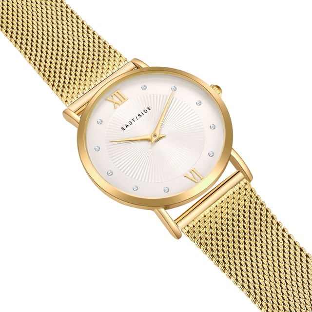 GENERAL INFORMATION:  • Targetgroup: Female  • Wristwatch: No Special Functions  • Display: analogue  • Weight of watch w/o box (gr.) - approx.: 48,0  MOVEMENT:  • Movement: Quartz  • Term of Movement: 2025  • Origin of movement: Japan  BRACELET:  • Material of bracelet/strap: Stainless steel  • Plating of bracelet/strap: Ion-Plating (IP)  • Finishing of bracelet/strap: Smooth  • Finishing/Decoration of bracelet/strap: None  • Clasp/Closure/Buckle: Slide Clasp  • Color of bracelet/strap: Yellowgold  • Length of bracelet/strap (mm) approx.: 200,0  • Width of bracelet/strap (mm) approx.: 17,6  • Style/Design of bracelet/strap: Mesh band (Millanaise Style)  • Bracelet/strap adjustable?: No  CASE:  • Shape of case: Round  • Size/Diameter of case in mm . approx.: 33,0  • Height of case in mm: 6,7  • Case material: Metal (Alloy)  • Surface of case: Polished  • Bezel/Topring: Fixed  • Finishing/Decoration of case: None  • Material of case back: Stainless steel  • Lock of case back: No screwed-in crown  • Color of case: Yellowgold  • Coating/Plating (Case): Ion-Plating (IP)  • Type/Form of crystal: Flat  • Material of crystal: Mineral crystal  • Water resistant (ATM): 3  DIAL:  • Size jewelry care cloth: Hour, Minute  • Indices: Roman numerals/points  • Material of dial: Brass  • Structure/pattern of dial: sunray  • Color of dial: White  PUSHER, CROWN, HAND:  • Pusher: None  • Corrector: No  • Crown: No screwed-in crown  • Type of hands: Dauphine hands  • Luminescent (hands): No  PACKAGING & SCOPE OF DELIVERY:  • Box: Yes  • Service booklet: Yes  • Manual: Yes