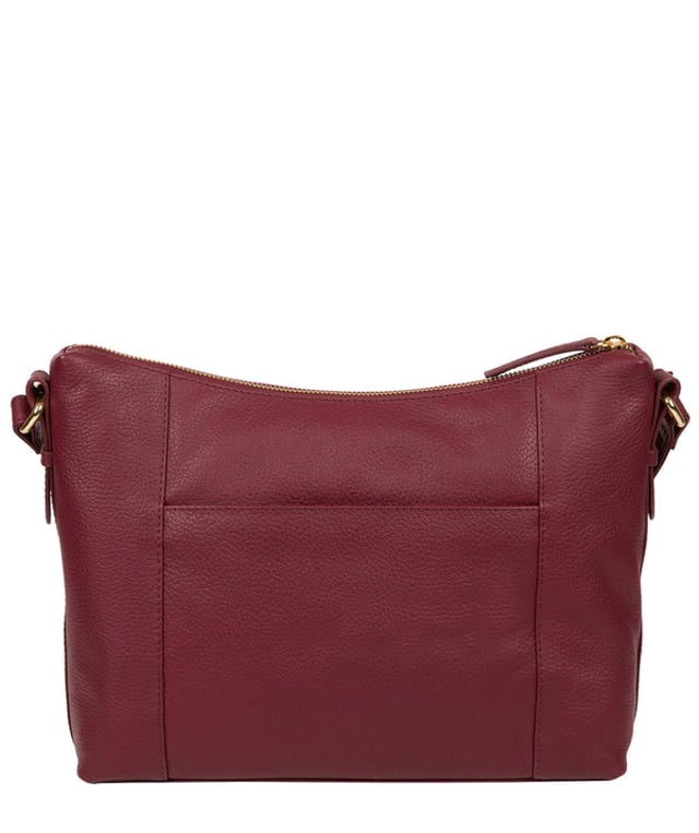 Crafted from leather that has soft pebble grain finish, the 'Jenna' shoulder bag from Pure Luxuries London comes with eye-catching gold-coloured fittings. The zip-over top secures a 100% cotton lined compartment, complemented by two internal pockets along with three external pockets that provide on-the-go storage; two of which are fastened with mock buckle press-studs. Comes with an adjustable matching leather strap and is adorned with the gold-coloured Pure Luxuries London charm and logo.