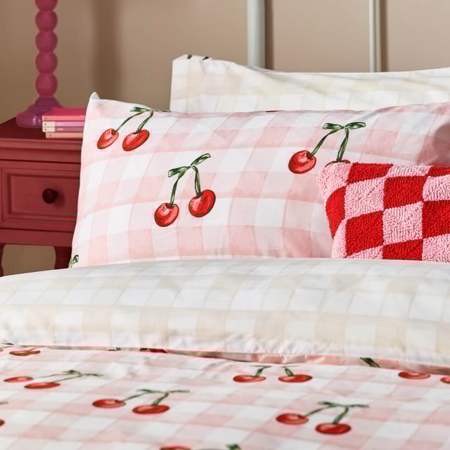 Introducing the Cherry Gingham Duvet Cover Set—a delightful blend of classic charm and modern flair perfect for those who cherish individuality. Crafted from high-quality 68 Pick Polycotton, this reversible duvet cover promises comfort and style in equal measure. The timeless gingham pattern is playfully adorned with bold red cherries, adding a touch of whimsy to your bedroom decor. Whether you're a positive thinker or someone who values unique self-expression, this bedding invites you to create a personal sanctuary that reflects your vibrant personality. Experience the joy of modern design with a touch of tradition, ensuring restful nights and chic aesthetics.