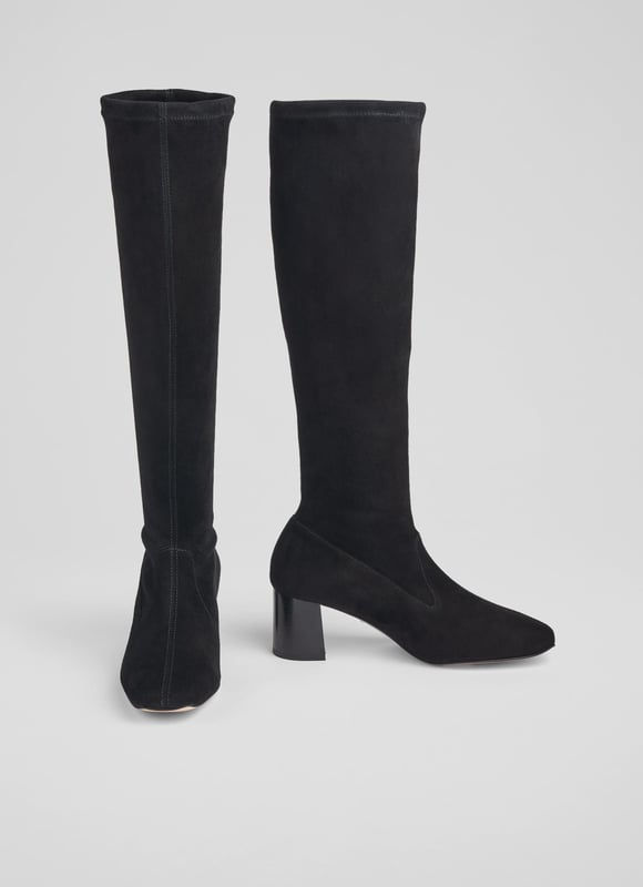 LK Bennett Davina Knee Boots, Black An elevated essential for any winter boot collection, our new Davina knee-boots offer a sleek look and a perfect fit. Crafted in Spain from beautiful black stretch suede, they have a square toe, a slim fit and a 60mm stacked block heel. Pull them on under winter skirts and dresses when it's time to up the winter layers.