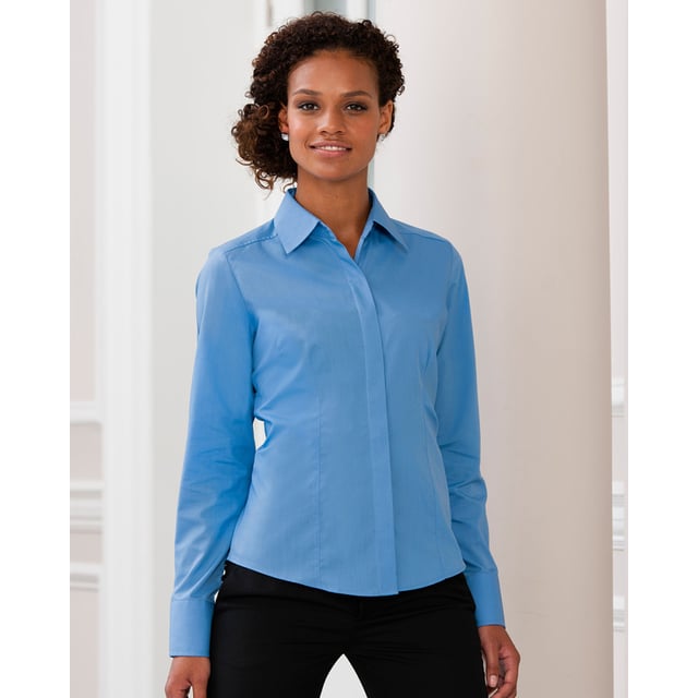 One of the great classic shirt fabrics, combining elegance with durability and wearer comfort. Smart and stylish fitted shirt design in a fine poplin fabric. Concealed placket. Stylish yoke design. Darts on bust front hem and back panel for fitted shape. Decorative top stitch on darts. Modern rounded 2 button cuffs. Rounded hem. The elegant lightweight fabric is especially suited for finer embroideries. Also available in mens sizes, code 924M. Weight: 110- 115g/m². Fabric: 65% Polyester, 35% Cotton. XS (30-32: To Fit (ins), 8: Dress Size). S (32-34: To Fit (ins), 10: Dress Size). M (34-36: To Fit (ins), 12: Dress Size). L (36-38: To Fit (ins), 14: Dress Size). XL (38-41: To Fit (ins), 16: Dress Size). 2XL (41-44: To Fit (ins), 18: Dress Size). 3XL (44-47: To Fit (ins), 20: Dress Size). 4XL (47-51: To Fit (ins), 22: Dress Size). RUSSELL COLLECTION - a variety of Mens and Womens corporatewear in a wide range of styles, colours and sizes.