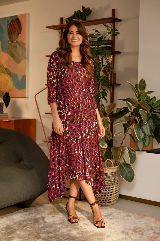 Add a vibrant animal print to your new season closet with this anima print midi dress. With a round neck, 3/4 sleeves, a hanky hem and a midi skirt. Style with strappy hees for a special event or pair with tights and block heeled boots to beat the chill.