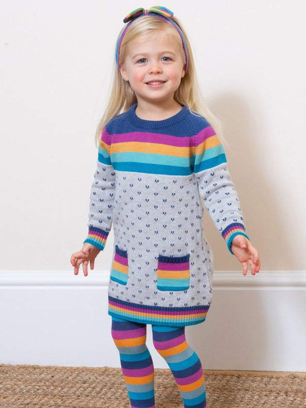 A fabulous midweight knitted dress featuring a stylish intarsia heart design. The lovely rainbow stripe featured on the chest, cuffs, hem and pockets adds some great pops of colour. This dress can be worn for a party or play and will feel cosy all the way! Wear with Kite's matching moonbow tights for a truly super outfit.