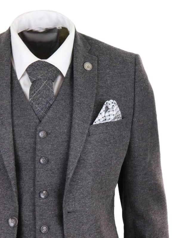A grey suit is a key staple in every mans wardrobe and this one is no exception to this unwritten rule. Sharp, sleek and sophisticated, look the part with this premium 3 piece grey wool tweed suit, that features a slim fit cut, with a closer fit across the chest and narrower tailored trousers. the two-button jacket hangs beautifully and has a half canvas construction that moulds to your body shape the more you wear it. Contrasting velvet pocket piping, buttoned cuffs and a single back vent lend the suit a classic touch of refinement. A matching tweed waistcoat completes the 3-piece with a single breasted down style with classic tailored pockets and a back adjuster to ensure you can create your ideal fit. The suit is evergreen and contemporary at the same time and allowing you to look the best all day. Pair it with a matching waistcoat, a white shirt and shoes for a dapper finish.