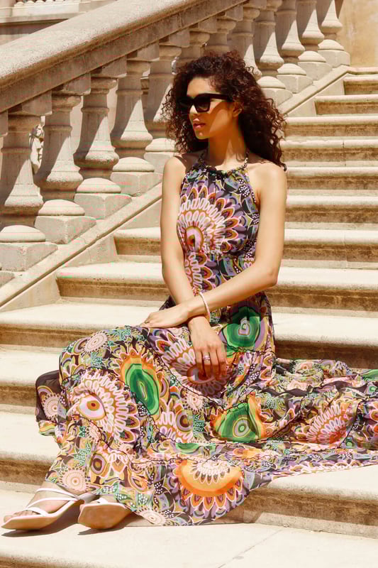Abstract Halter Neck Tiered Maxi Dress from Roman. Give a nod to the psychedelic 70’s with this printed maxi dress. Cut from a smooth woven fabric this piece features a modest round neckline and is designed in a Summer-ready sleeveless, halter neck style. Adorned in a mesmerising mixed print this piece falls in tiers in a fit and flare style to a modest maxi length. Pair with barely-there heels and a jacket for a garden party or add sandals and a light knitted cardigan for evening beach walks!