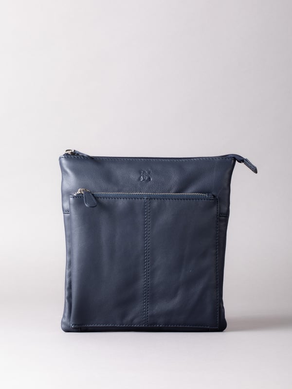 Welcome portable style into your handbag collection with the slimline yet pocket-packed Enderby cross body bag in easy-to-style navy.Crafted from soft and smooth leather, this bag features a large front zip and rear zip pocket on the outside for easy access valuables, and the interior boasts zip and slip pockets to ensure you stay organised on the go.The adjustable shoulder strap makes the Enderby ideal for everyday use, big enough for your essentials but superbly lightweight.The DetailsStyle: Enderby Leather Cross Body BagColour: NavyMaterial: LeatherDimensions: W22 x H24 x D2cmAdjustable leather strapAdjustable strap drop: Max 76cm - min 36cmZip top fastening with leather pullerLarge front zip pocketRear zip pocket And On The InsideOne zip pocketOne slip pocketFabric lining