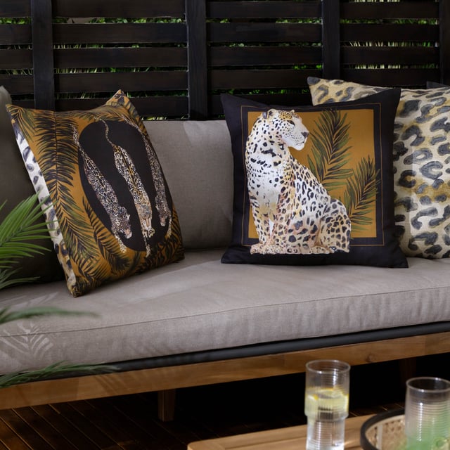Elevate your outdoor space with the Leopardis Cat Outdoor Cushion, where artistry meets functionality. Designed with a subtly refined texture, the soft-touch material has been specially treated for outdoor durability. This water-resistant cushion is easy to wipe clean, making it as practical as it is elegant. Its hand-painted motif is set against a backdrop that beautifully complements any outdoor setting. Complete with a sleek contrasting border, this luxe cushion lends an air of sophistication and detail, ensuring it stands out as a statement piece while harmonising with your stylish outdoor décor.