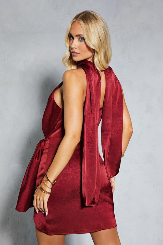 Textured satin fabric for a luxurious look and feel
        High neck design with elegant scarf detail
        Flattering ruched wrap silhouette
        Sleeveless style with open back feature
        Mini length perfect for showcasing legs
    
    Make a statement at your next special occasion with this show-stopping mini dress from Misspap. The textured satin fabric catches the light beautifully, whilst the ruched wrap design creates a figure-hugging silhouette that's sure to turn heads. The high neck and scarf detail add a touch of sophistication, perfectly balanced by the daring open back. Style this versatile piece with strappy heels and statement earrings for a glamorous evening look. Whether you're attending a cocktail party, a wedding reception, or a night out on the town, this dress is designed to make you feel confident and fabulous. The mini length is ideal for those who love to show off their legs, while the sleeveless cut allows for easy movement on the dance floor. This Misspap dress is the ultimate choice for the fashion-forward woman who isn't afraid to stand out from the crowd.