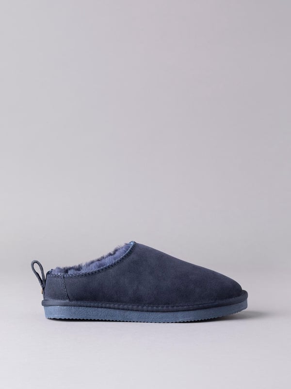 Our sheepskin clog slippers are just the remedy against chilly toes in the colder months. Crafted from 100% natural sheepskin with cushioned air-pocket insole, you won't believe how warm and comfy they are until you try them. Featuring a hard-wearing rubber sole and a tab with branded stud for ease of getting them on and off (although you'll never want to be out of them!), these clog slippers really are a winter essential. The natural fluffiness of the sheepskin will make your slippers feel slightly small at first but this will soon mould comfortably to your foot. If the length feels fine, you have the right size. If you can feel your toe is touching the front of the slipper, it is too small, you'll need to size up. We recommend you size up if you are between sizes.