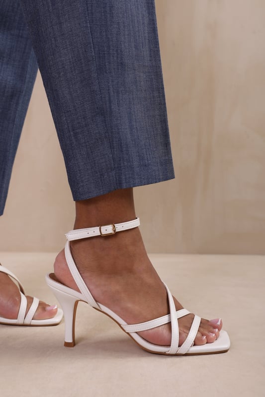Step out in style and sophistication with our Austin Wide Fit Multi Strap Cross Over Mid Heels. These stunning heels are designed to elevate your outfit and add a touch of glamour to your every step.

Key Features:



Strappy Design: The multi-strap detail adds an elegant and polished touch to these shoes, making them the perfect option for those who want to make a fashion statement.

Comfortable Height: The mid-high heel provides stability and support, while the cushioned insole ensures all-day comfort. Walk confidently knowing that your feet will stay comfortable, no matter where the day takes you.

Open Toe: Open toe design adds a chic and fashionable element to these high heels, showcasing your pedicure and adding sophistication to any outfit.


Specifications:


Material: Faux Leather
Heel Height: 2’ (5.08cm) approx
Strap Detail: Multi-strap design adds elegance and polish to these shoes
Closure: Buckle closure for a secure and adjustable fit

Elevate your style and make a statement with our Austin Wide Fit Multi Strap Cross Over Mid Heels. These shoes combine fashion and functionality, allowing you to showcase your individuality while enjoying all-day comfort. Step out with confidence and embrace your inner trendsetter.