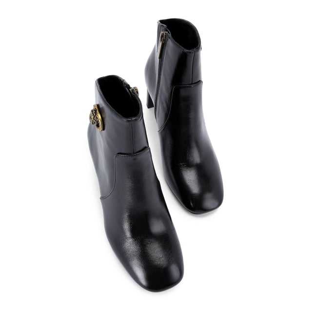 This Kurt Geiger Chelsea Square Toe Bootie is crafted from a black leather. There is an antiqued brass buckle with eagle head that is embellished with crystals sat on the outer side of the ankle. Heel height: 7.5cm.