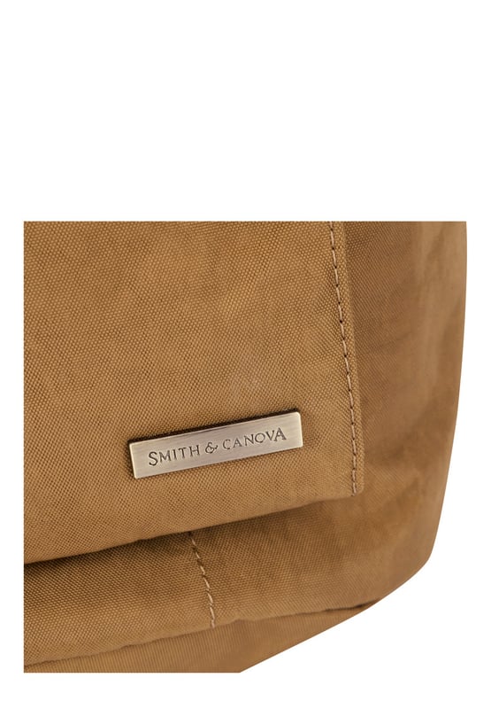 The Zip Around Nylon Backpack is the go-to bag for everyday essentials. The classic silhouette is cut in our signature nylon featuring a flap over zip pocket to the front. Inside features a 15” padded laptop sleeve with additional internal pockets for organised storage. Features: , Zip top opening, Front flap over zip pocket, Rear zip pocket, SMITH & CANOVA antique brass logo, Branded antique brass zips, Padded grab handle, Adjustable padded backpack straps, Internal 15 inch padded laptop sleeve, Internal zip pocket, 2 Internal mobile phone slip pockets - fits normal and plus size smart phones, 2 Internal pen slip pockets Style Ref: 92681 TAN