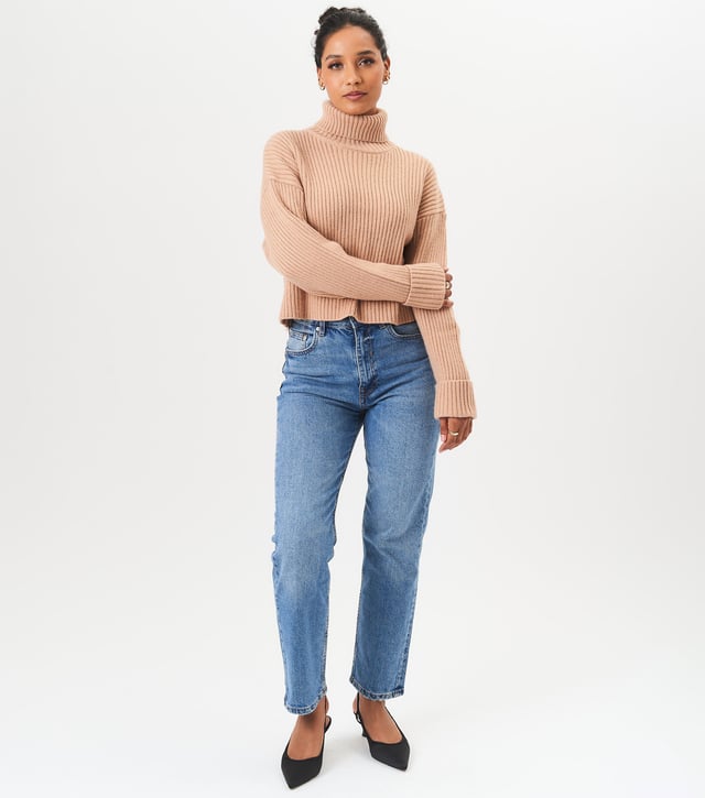Stay cozy and stylish this season with our High Neck Chunky Knit Crop Jumper. Made with high quality materials, this jumper will keep you warm and on trend. The high neck adds a touch of fashion while the chunky knit provides both comfort and durability. Perfect for layering or wearing on its own, this jumper will be a staple in your wardrobe.MeasurementApprox. length- 60 cm