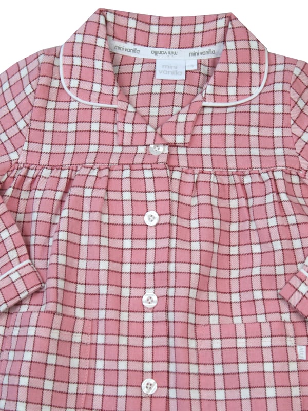 Our girls peony pink cotton pyjama set is where comfort meets feminine elegance. Made from soft and breathable cotton, these pyjamas are perfect for a restful night's sleep or lounging in style. The delightful peony pink check design adds sophistication to bedtime, making it a lovely experience for your little girl. Let her embrace a blend of comfort and fashion with these classic pyjamas, designed for a cosy nights and fashionable lounging.