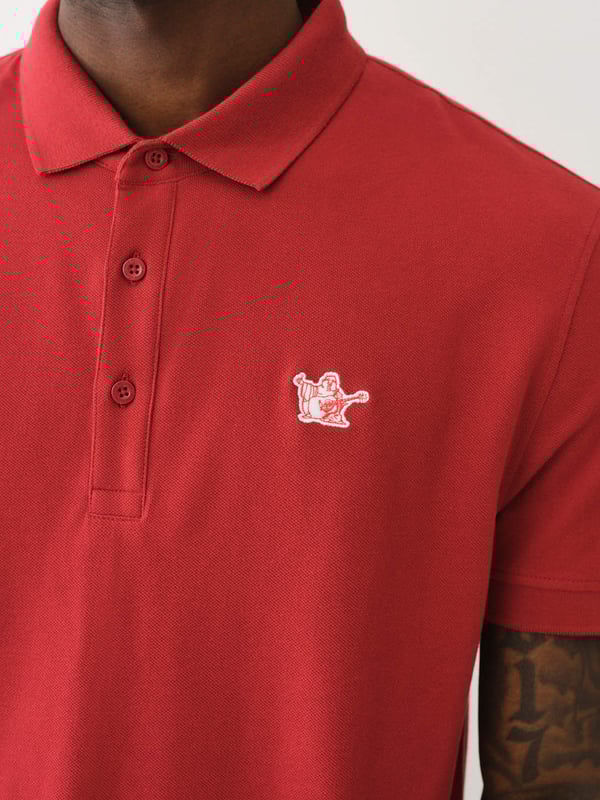 Pop that collar with the Buddha Patched Logo Polo Shirt. Crafted from soft cotton, this men’s polo features a basic collar. half-button placket, and short sleeves. Finished with a relaxed fit, ribbed trim, and a chest Buddha patch.