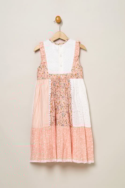 Let your little one blossom in this Miss floral patchwork dress! Designed with a keyhole tie neck and cute frill sleeves, it's a delightful addition to her wardrobe. Each patch tells a floral story, adding charm to every wear. Perfect for your stylish sweetheart to shine in any setting.