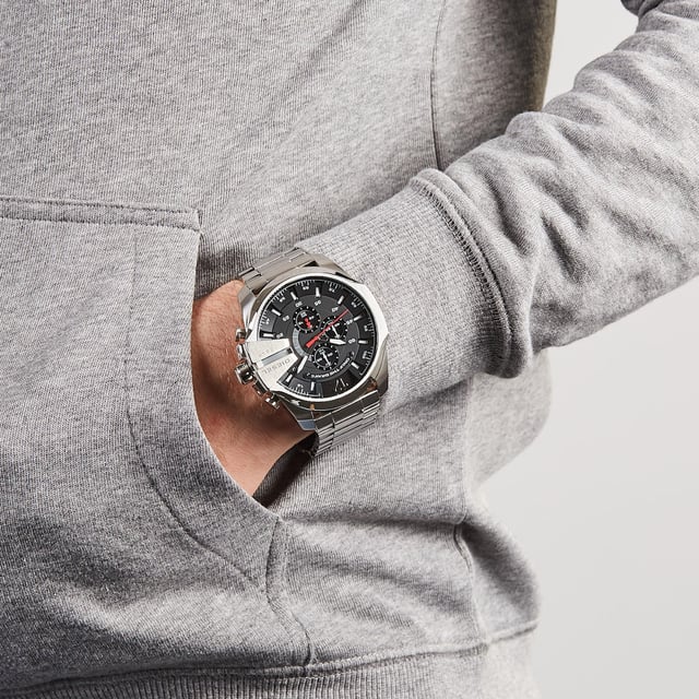 This Diesel Mega Chief Chronograph Watch for Men is the perfect timepiece to wear or to gift. It's Silver 51 mm Round case combined with the comfortable Silver Stainless steel watch band will ensure you enjoy this stunning timepiece without any compromise. Operated by a high quality Quartz movement and water resistant to 10 bars, your watch will keep ticking. This sporty and fashionable watch gives you a unique feeling in every outfit! -The watch has a calendar function: Date, Stop Watch, Luminous Hands, Luminous Numbers High quality 21 cm length and 26 mm width Silver Stainless steel strap with a Fold over with push button clasp Case diameter: 51 mm,case thickness: 14 mm, case colour: Silver and dial colour: Black