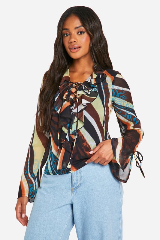 This season, we're turning up the heat - and turning heads, so this going out top is an absolute wardrobe staple. Create outfit after outfit in all kinds of styles; a party top teamed with a cute pair of jeans or trousers is always perfect for that lowkey going out look. From sequin tops to satin styles, evening tops always make an impression when thrown together with a chic skirt or shorts. If there's one thing this stylish top is, it's statement-making.Style: BlouseDesign: AbstractFabric: ChiffonLength: RegularNeckline: V NeckSleeve Length: Long Sleeve