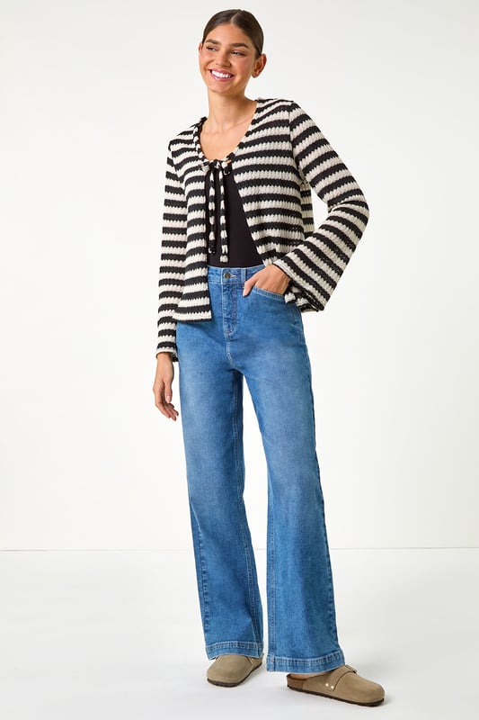 Striped Print Tie Detail Cardigan from Roman. Stay warm and stylish this Autumn with our stripe print cardigan. Crafted from a cosy pointelle knit fabric, this cardi features a trendy tie front fastening, perfect for layering on those cooler days. The hip-length design and long sleeves ensure a comfortable and flattering fit. Pair with jeans and ankle boots for a chic and effortless daytime style.