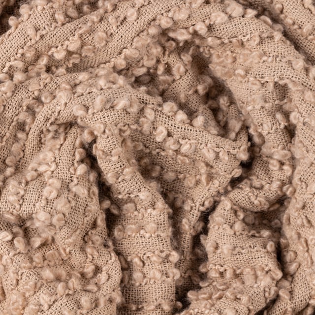 Add instant style and texture to any space with the Arvo throw. This woven design is adorned with elegant strands of vertical boucle yarn, which slide gracefully down the piece, until they meet the textural fringing at both ends. It comes in a range of muted, chic tones, which are inspired by modern neutrals and fashion fabrics. A simple, but polished throw to drape on your sofa or bed to add instant style and texture to your home.