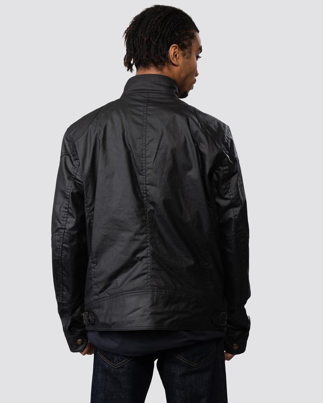 The Racemaster jacket in Faded Olive. There’s more to the Racemaster than meets the eye. Introduced back in 1981, it was originally billed as a shorter version of the iconic Trialmaster. This means that, along with the history, heritage, and dark navy 6 oz. waxed cotton, you also get increased mobility and freedom to move.

6 oz. waxed cotton, with a unique blend of micro and technical waxes
Four external pocket field jacket with reinforcement patches and corduroy details
Water-repellent and wind-repellent
Corduroy linings at the collar, cuffs and hem providing added comfort and resilience at high contact points
Signature antique brass metal hardware with Belstaff England engraved on the round and signature phoenix woven patch on left sleeve
Centre front zip closure with snap closure placket
Buckle-adjusted collar
Two press-stud flap pockets
Two lower zipped pockets
Left internal pocket

Shell: 100% Cotton, Body Lining: 100% CottonSleeve Lining: 55% Polyester, 45% Viscose/Rayon105306