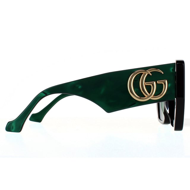 Gafas de sol Gucci cuadradas para mujer en negro y verde con espirales. Gucci presenta un marco de acetato súper grueso con patillas anchas y un logotipo GG metálico entrelazado extra grande.
