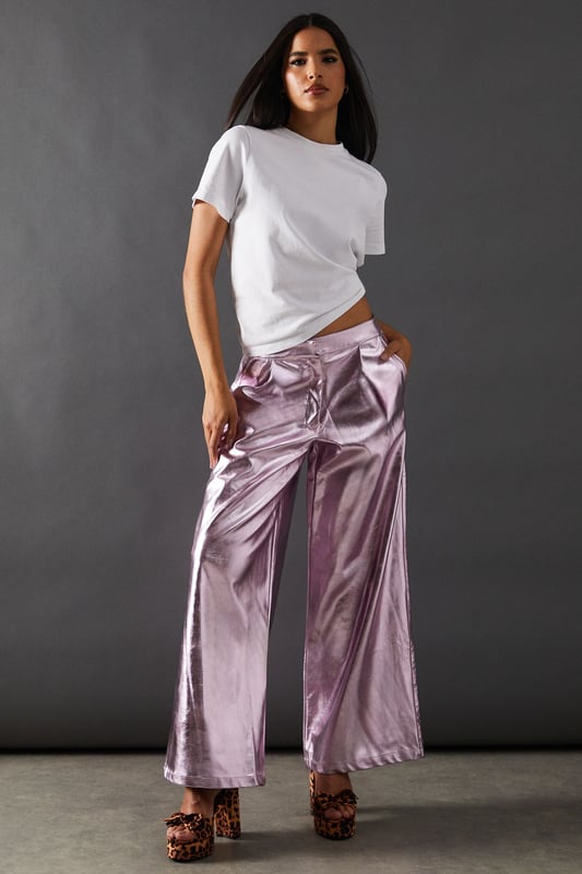 Eye-catching metallic finish for a bold statement
        Wide leg silhouette for a comfortable and trendy fit
        High-waisted design accentuates the waistline
        Front zip and button fastening for a secure fit
        Versatile style suitable for various occasions
    
    Make a dazzling entrance with these striking metallic wide leg jeans from Warehouse. Perfect for those who dare to stand out, these trousers combine comfort with high-impact style. The wide leg cut offers freedom of movement while creating a fashionable silhouette. For a night out on the town, pair these show-stopping trousers with a crisp white shirt, leaving it partially unbuttoned for a relaxed yet chic look. Add some platform sandals to elongate your legs and complete the ensemble with statement earrings. Whether you're hitting the dance floor or enjoying drinks with friends, these jeans will ensure you're the centre of attention. Their versatility also allows for more casual styling - try pairing with a simple black tee and trainers for an effortlessly cool daytime look that transitions seamlessly into evening wear.