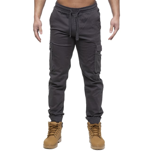 Enzo Mens Elasticated Waist Stretch Cuffed Jeans. Features a 5 Pocket Design. 2 Slash Pockets, 1 Back Pocket 2 Front Cargo, Bellow Side Pockets With Velcro Fastening. Elasticated Waist With Adjustable Drawstings. Cut and Sew Design On Leg. Cuffed Ankle