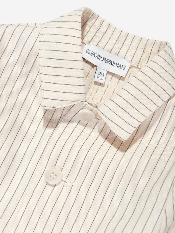 Emporio Armani Baby Boys Striped Linen Jacket in Ivory Presenting the luxurious Baby Boys Striped Linen Jacket in Ivory from the revered design house, Emporio Armani. Ideal for the celebratory occasion of Eid. Key features are: Sophisticated Design: The elegant striped pattern exemplifies class, making your little boy the cynosure of the occasion. Lavish Comfort: Crafted from fine-grade linen, it ensures your child experiences absolute comfort all day long. Couture Wardrobe Update: This stylish linen jacket is poised to revamp your Baby Boy's wardrobe, adding a unique touch of Emporio Armani's signature style. Let your little one bask in the limelight this Eid!