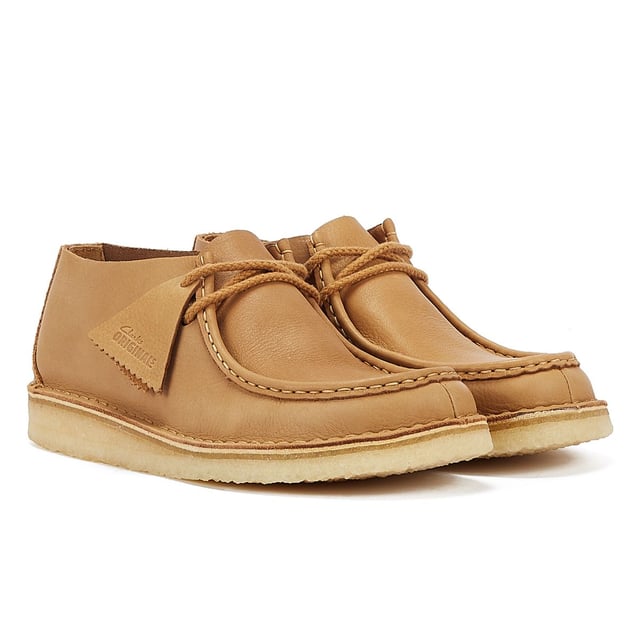 Introducing the Nomad shoe, a fusion of Wallabee and Desert Trek styles, boasting hand-stitched details. Crafted from premium mid tan leather upper for durability and style. Finished with a lightweight pebble crepe sole for added comfort and traction.