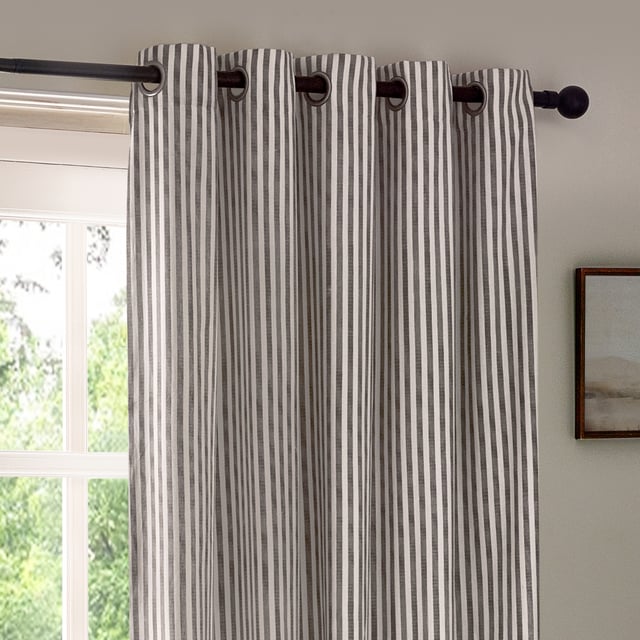 Transform your living space with Hebden Striped Eyelet Curtains. Crafted from 100% cotton, these woven striped curtains offer a super soft yet durable finish, ensuring long-lasting beauty and ease. Perfectly balancing style and substance, the versatile design exudes a classic minimalist charm, while the room-darkening lining adds practicality. Whether you're seeking serenity or a restful night’s sleep, these curtains deliver quality, making them an essential addition for those who cherish natural materials and refined aesthetics.