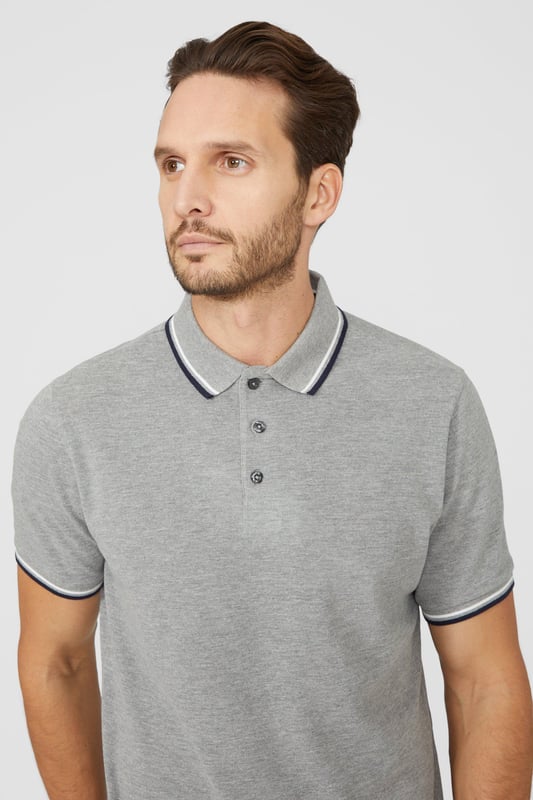 Introducing our Pique Tipped Polo, the perfect addition to any man's smart casual wardrobe. Crafted with meticulous attention to detail, this polo offers a sophisticated and polished look. The pique fabric provides a comfortable and breathable feel, making it ideal for all-day wear. With its stylish tipped collar and cuffs, this polo adds a touch of elegance to any outfit. Whether you're heading to the office or out for a casual gathering, our Pique Tipped Polo is the ultimate choice for a smart and effortlessly stylish look.